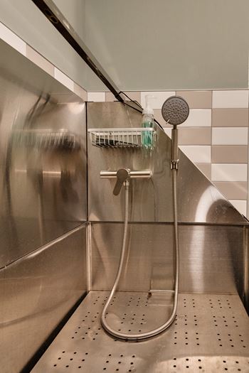 A shower head with a hose attached to it